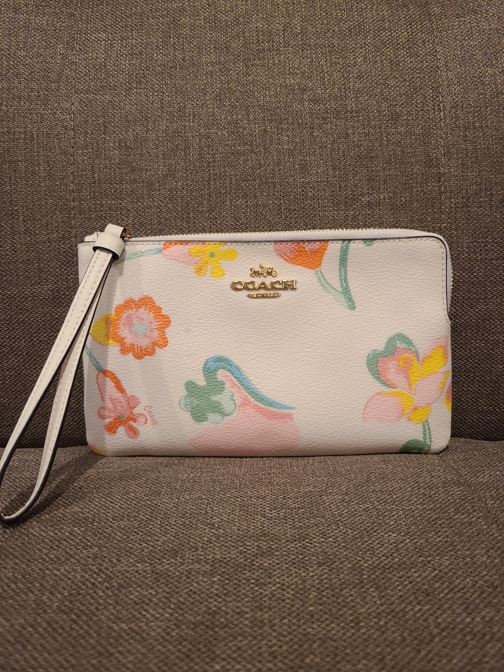 Coach Large Corner Zip Wristlet features the colorful Dreamy Land Floral print